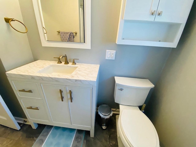 half bath with vanity, toilet, and wood finished floors