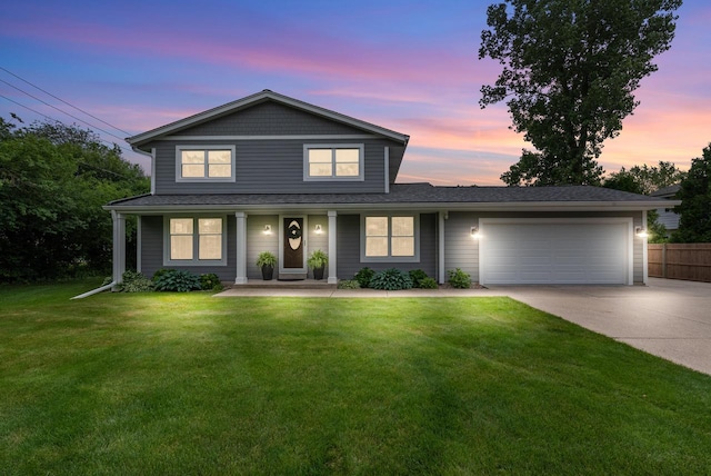 traditional-style home featuring fence, a front yard, concrete driveway, an attached garage, and a porch