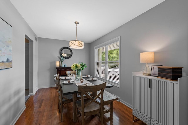 dining room with baseboards, wood finished floors, and visible vents