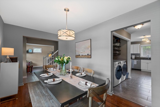 dining area featuring separate washer and dryer, baseboards, dark wood-style floors, and stairway