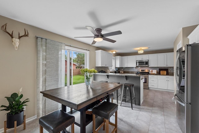 dining area featuring light tile patterned flooring and ceiling fan