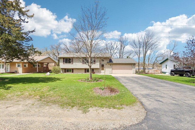 N6376 Hillcrest Rd, Pardeeville, WI 53954 - raised ranch featuring a garage, a front yard, and aphalt driveway