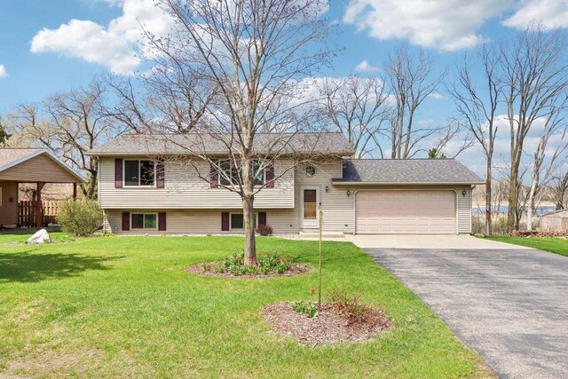 N6376 Hillcrest Rd, Pardeeville, WI 53954 - tri-level home with an attached garage, a front yard, and aphalt driveway