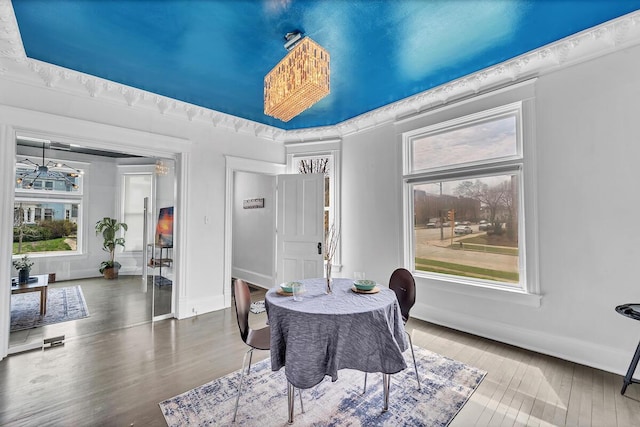 dining space featuring baseboards and wood finished floors