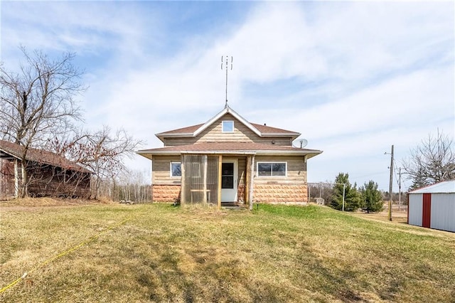 W12141 Hwy 8, Bruce, WI 54819 - back of property with a yard, roof with shingles, an outdoor structure, and stone siding