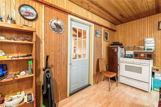 W12141 Hwy 8, Bruce, WI 54819 - interior space featuring wooden walls, wooden ceiling, white gas range oven, and light wood finished floors