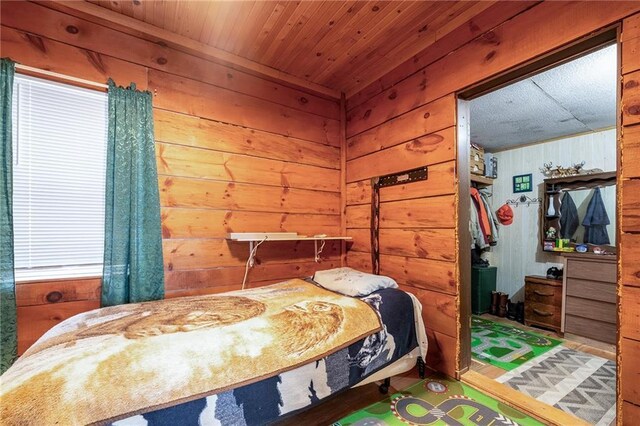 W12141 Hwy 8, Bruce, WI 54819 - bedroom featuring wood walls and wood ceiling