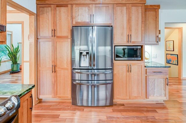6610 Whittlesey Rd, Middleton, WI 53562 - kitchen with stainless steel appliances, light wood-style flooring, stone counters, and light brown cabinetry