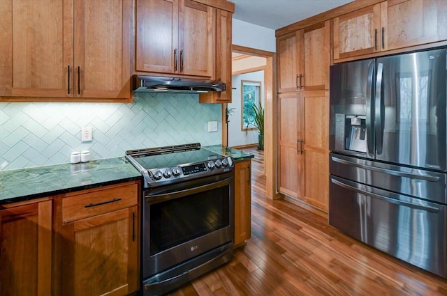 6610 Whittlesey Rd, Middleton, WI 53562 - kitchen featuring black refrigerator with ice dispenser, stainless steel range with electric stovetop, under cabinet range hood, backsplash, and dark wood-style floors