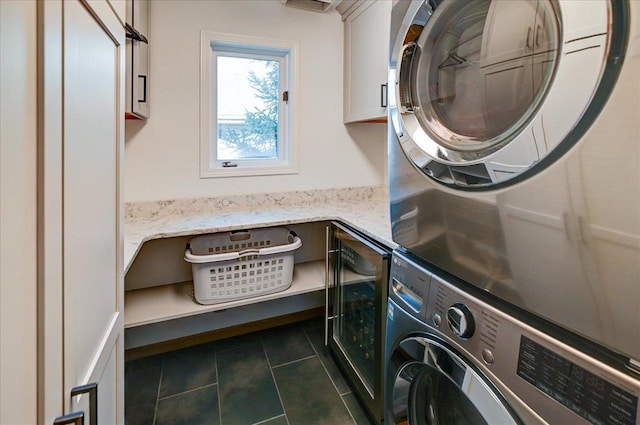 6610 Whittlesey Rd, Middleton, WI 53562 - laundry room with cabinet space, stacked washer / drying machine, dark tile patterned flooring, and beverage cooler