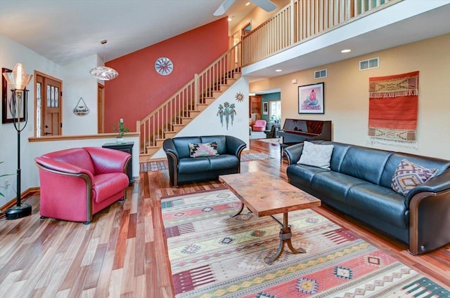 6610 Whittlesey Rd, Middleton, WI 53562 - living area featuring wood finished floors, stairs, a high ceiling, and baseboards