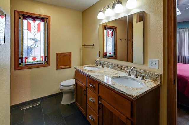 6610 Whittlesey Rd, Middleton, WI 53562 - full bathroom featuring double vanity, toilet, and baseboards