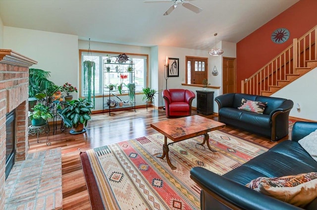 6610 Whittlesey Rd, Middleton, WI 53562 - living area featuring a fireplace, stairway, wood finished floors, baseboards, and a ceiling fan
