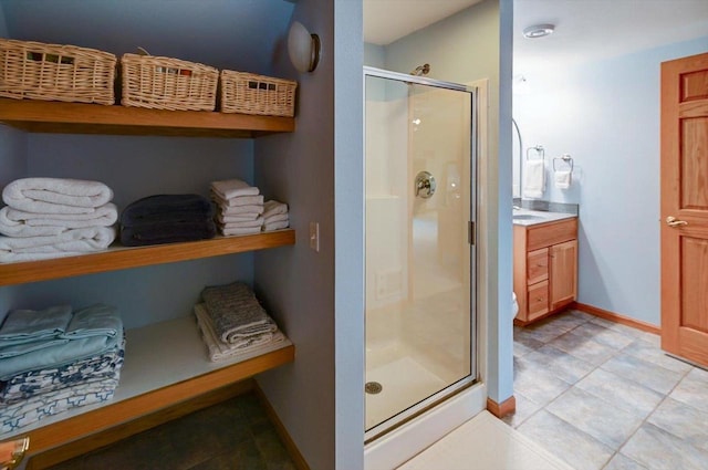 6610 Whittlesey Rd, Middleton, WI 53562 - bathroom with a shower stall, baseboards, tile patterned floors, and vanity