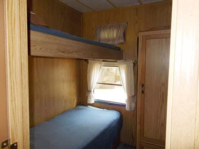 bedroom with wooden walls