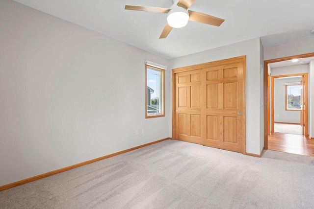 7605 W Windrush Ln, Franklin, WI 53132 - unfurnished bedroom featuring baseboards, carpet flooring, a ceiling fan, and a closet