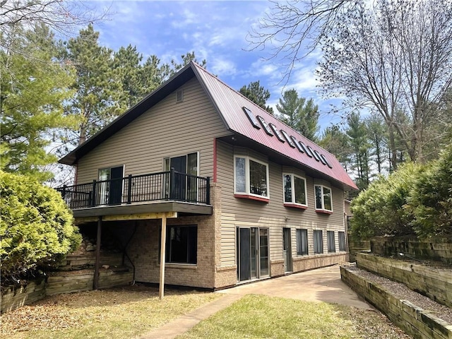 7672 178th St, Chippewa Falls, WI 54729 - rear view of house with metal roof and a patio area