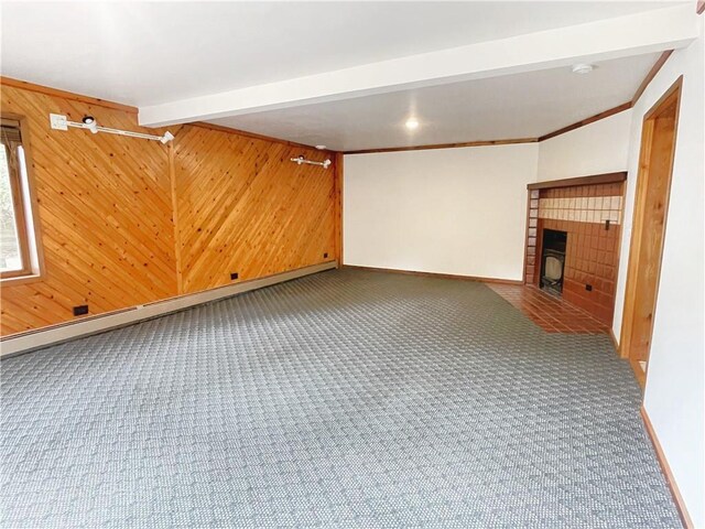 7672 178th St, Chippewa Falls, WI 54729 - basement with carpet flooring, a tiled fireplace, wooden walls, baseboards, and baseboard heating