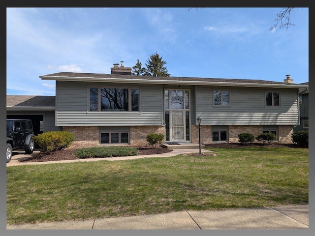 5401 Comanche Way, Madison, WI 53704 - split foyer home with a chimney and a front lawn