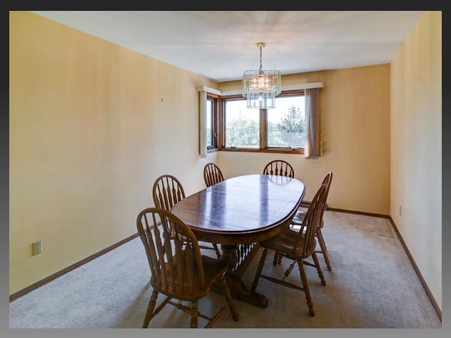 5401 Comanche Way, Madison, WI 53704 - dining area with carpet, a chandelier, and baseboards