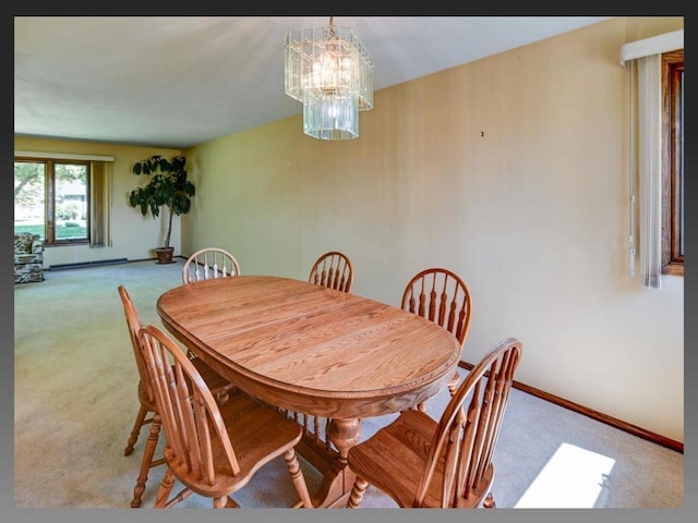 5401 Comanche Way, Madison, WI 53704 - dining space with light carpet, a chandelier, baseboards, and a baseboard radiator