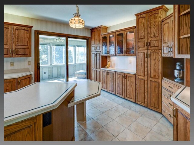 5401 Comanche Way, Madison, WI 53704 - kitchen featuring brown cabinetry, decorative light fixtures, light countertops, and light tile patterned floors