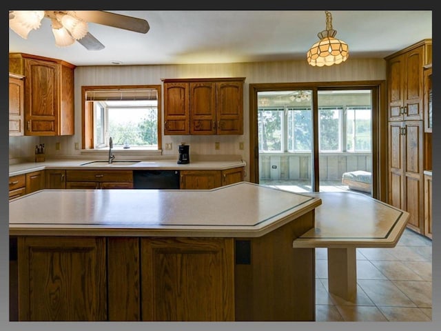5401 Comanche Way, Madison, WI 53704 - kitchen featuring a sink, dishwasher, light countertops, a kitchen island, and a ceiling fan