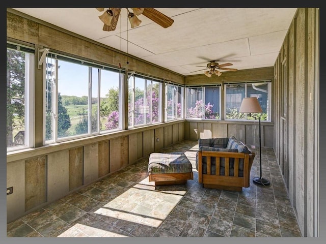 5401 Comanche Way, Madison, WI 53704 - sunroom with a ceiling fan, an outdoor living space, wooden walls, and stone finish flooring