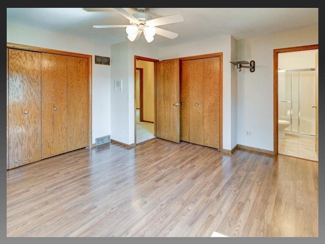 5401 Comanche Way, Madison, WI 53704 - unfurnished bedroom featuring wood finished floors, baseboards, two closets, ensuite bathroom, and ceiling fan