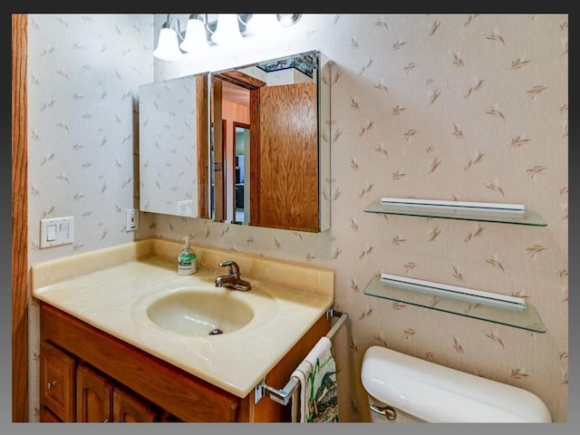 5401 Comanche Way, Madison, WI 53704 - bathroom with toilet, vanity, and wallpapered walls