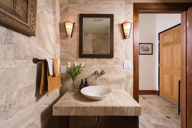 bathroom with a sink and baseboards