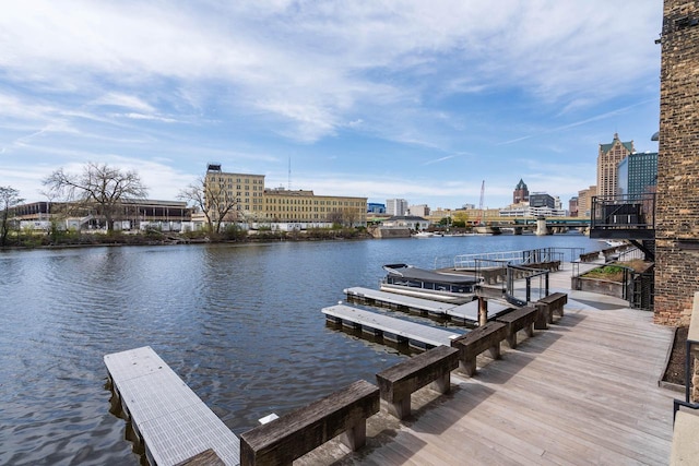 dock area featuring a water view and a view of city