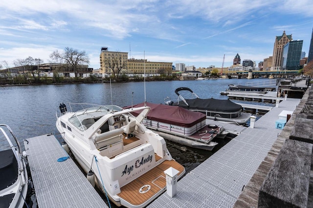 view of dock featuring a city view and a water view