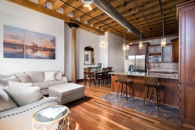 living room featuring beam ceiling and dark wood-type flooring
