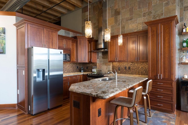 kitchen with decorative backsplash, stainless steel appliances, light stone counters, and a towering ceiling