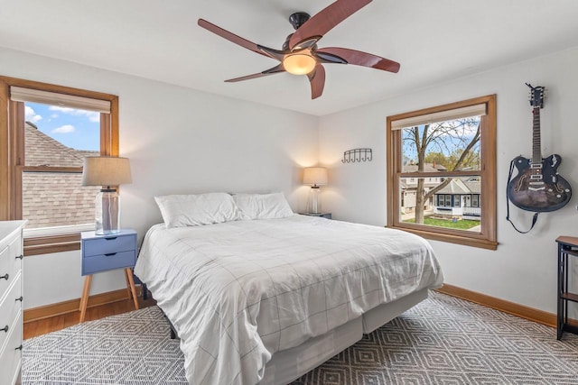 bedroom featuring baseboards, a ceiling fan, and wood finished floors