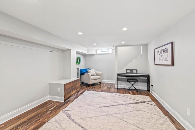 sitting room with baseboards, recessed lighting, and dark wood-style flooring