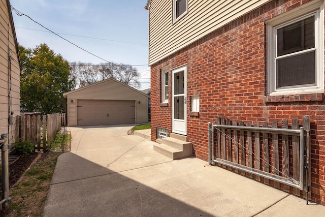 view of side of property with brick siding, a garage, an outbuilding, and entry steps