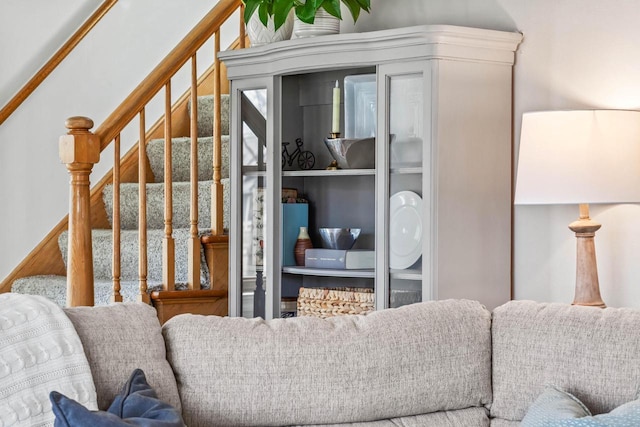 living room featuring stairway