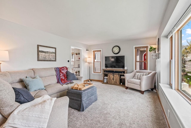 living room featuring baseboards and light carpet