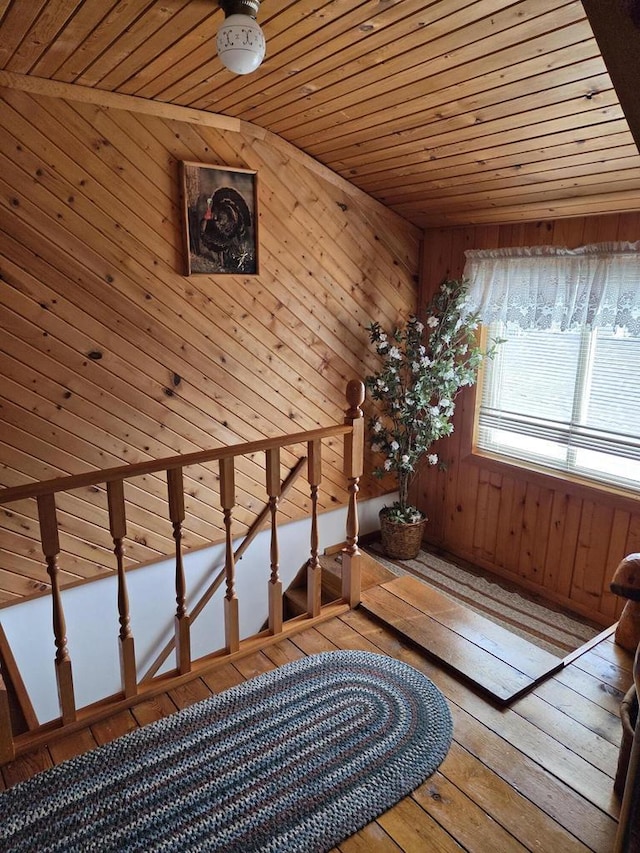 interior space with wooden walls, wooden ceiling, and hardwood / wood-style floors