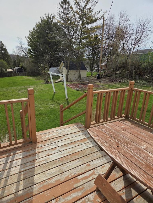 wooden terrace featuring a lawn