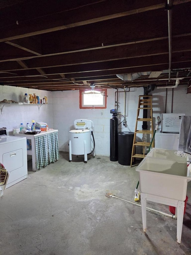 below grade area featuring separate washer and dryer and a sink