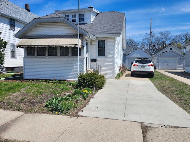 7607 15th Ave, Kenosha, WI 53143 - bungalow with a detached garage, an outbuilding, entry steps, and roof with shingles