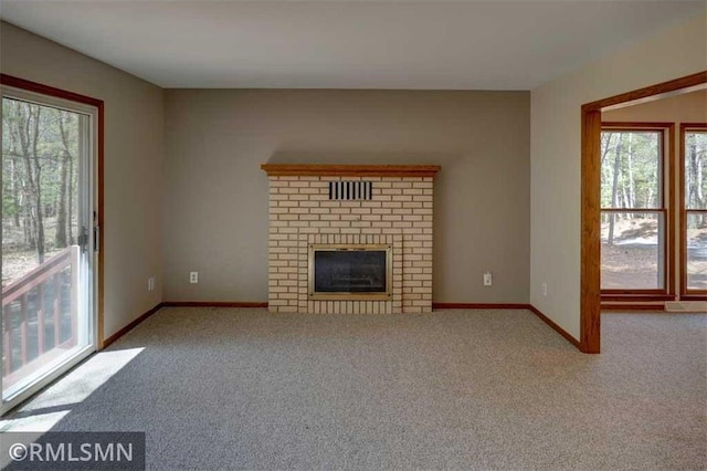 890 Lincoln Ave, Amery, WI 54001 - unfurnished living room with baseboards, carpet flooring, and a brick fireplace