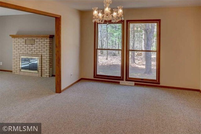 890 Lincoln Ave, Amery, WI 54001 - unfurnished living room featuring baseboards, carpet, and a notable chandelier