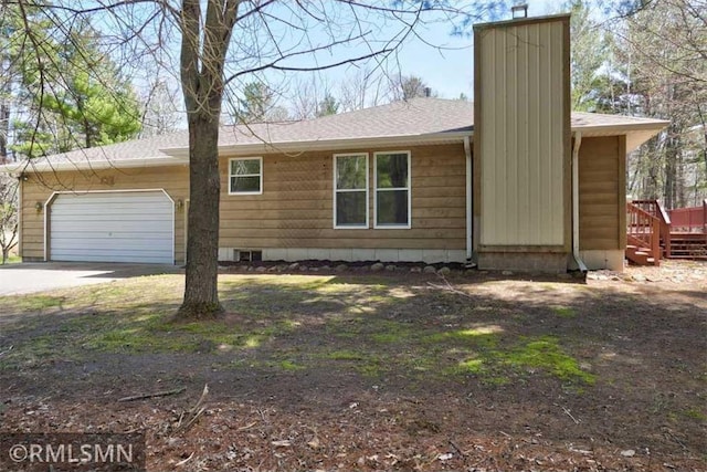 890 Lincoln Ave, Amery, WI 54001 - view of front of house with concrete driveway, an attached garage, a chimney, and roof with shingles