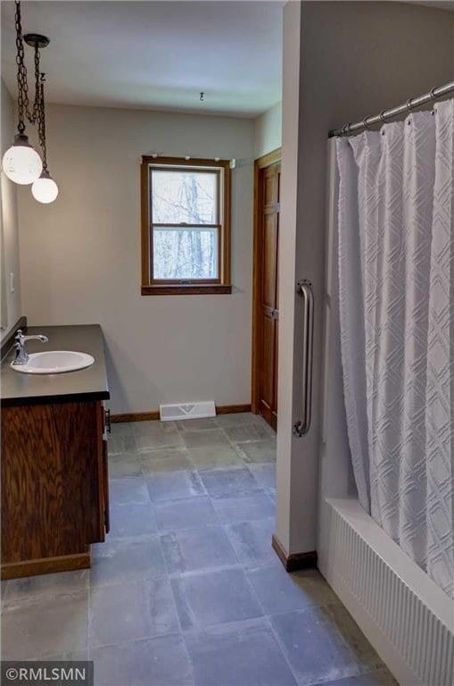 890 Lincoln Ave, Amery, WI 54001 - bathroom featuring visible vents, baseboards, shower / tub combo, and vanity