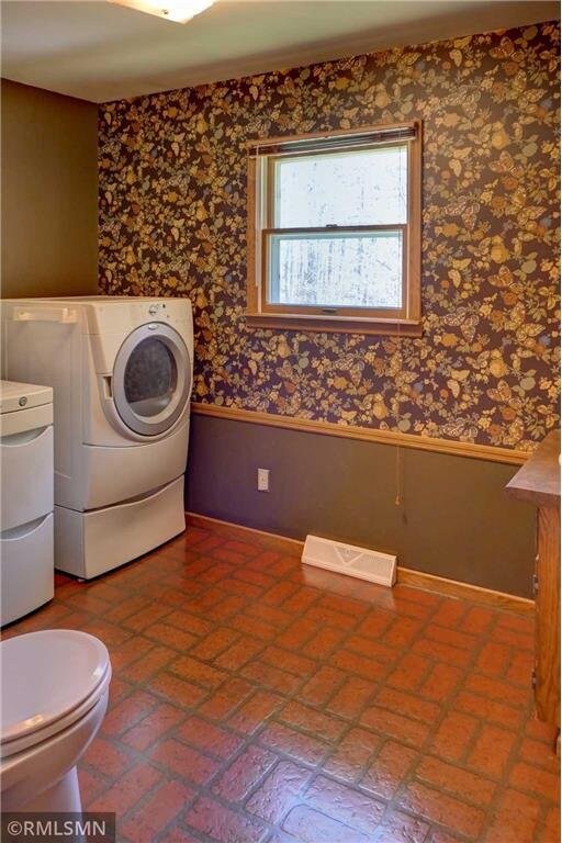 890 Lincoln Ave, Amery, WI 54001 - laundry room featuring washer and dryer, laundry area, wainscoting, wallpapered walls, and visible vents