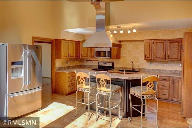 890 Lincoln Ave, Amery, WI 54001 - kitchen featuring stainless steel appliances, a breakfast bar, brown cabinetry, and a sink
